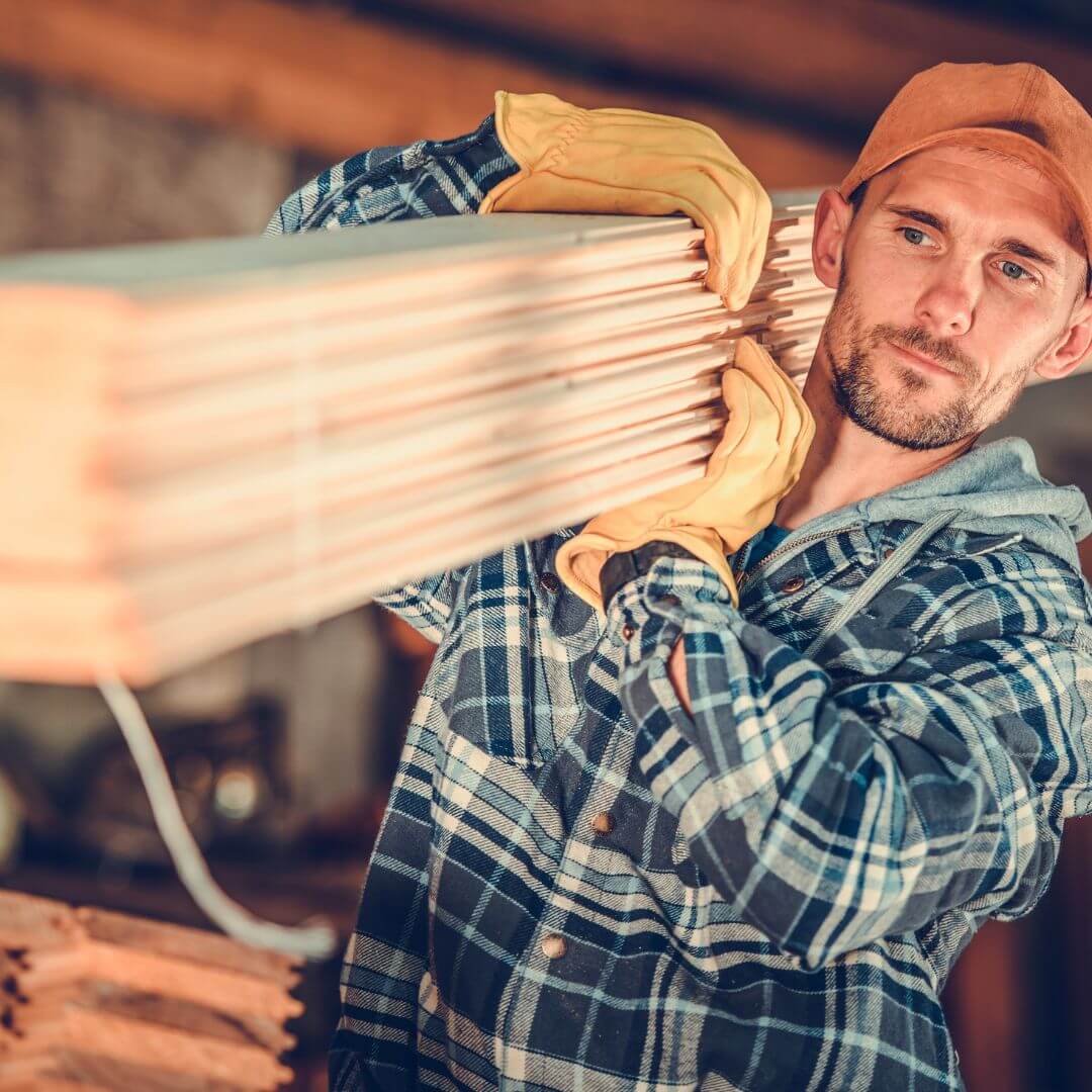 Construction Worker carrying lumber