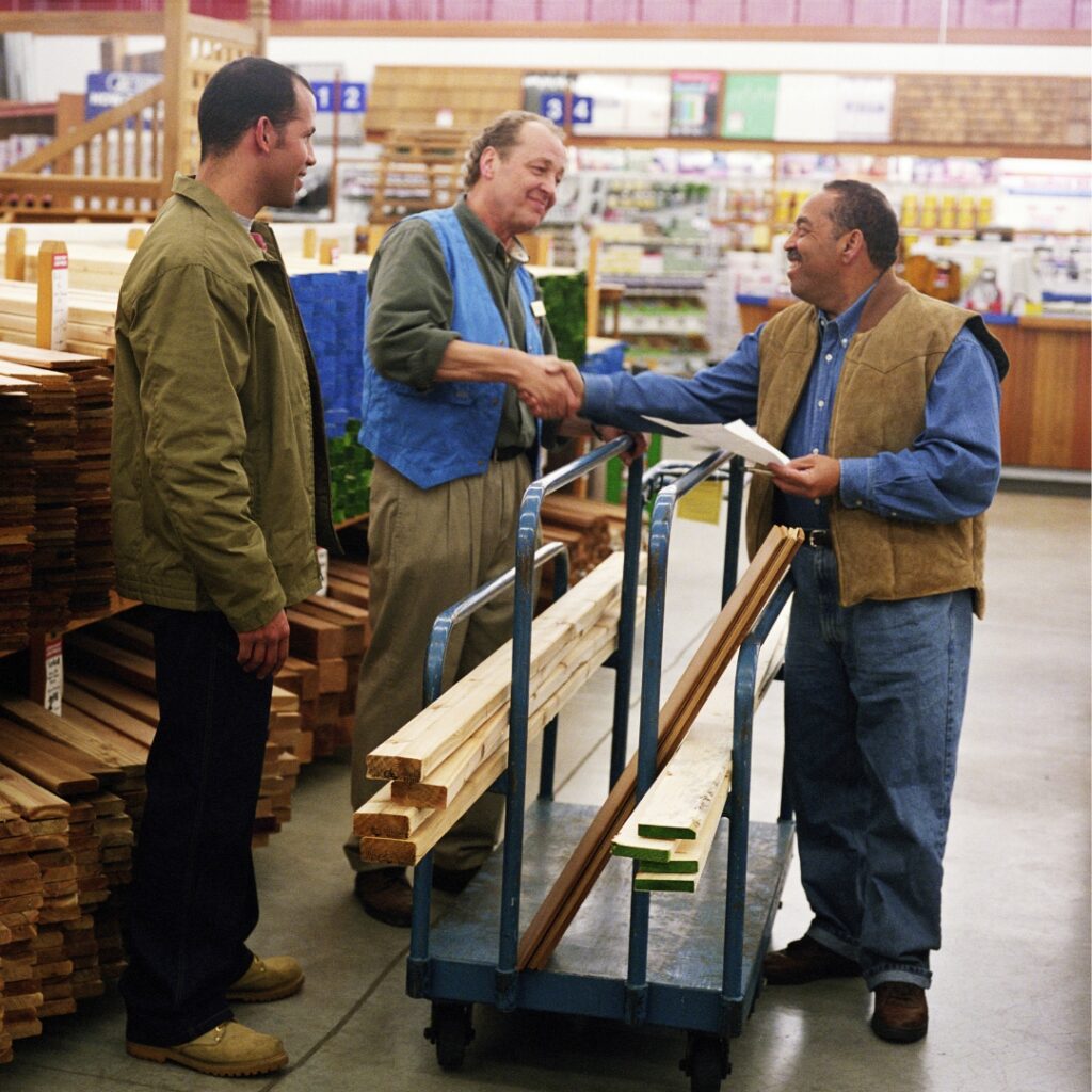 men at hardware store talking about lumber