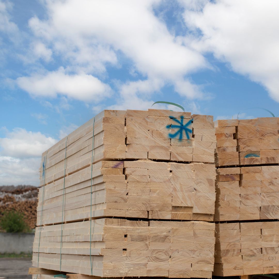 lumber stacked in lumber yard